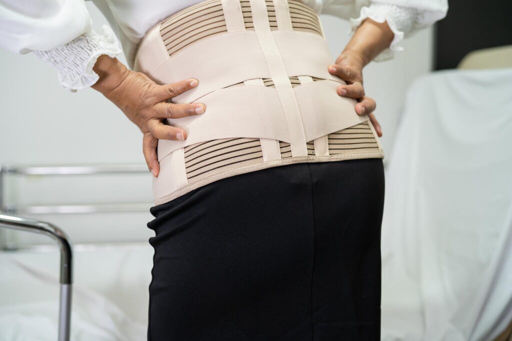 asian lady patient wearing back pain support belt orthopedic lumbar with walker 39768 8462