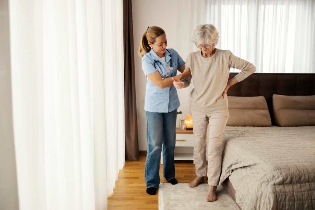 nurse is helping senior woman with walking around bedroom nursing home 232070 24495 nurse is helping senior woman with walking around bedroom nursing home 232070 24495