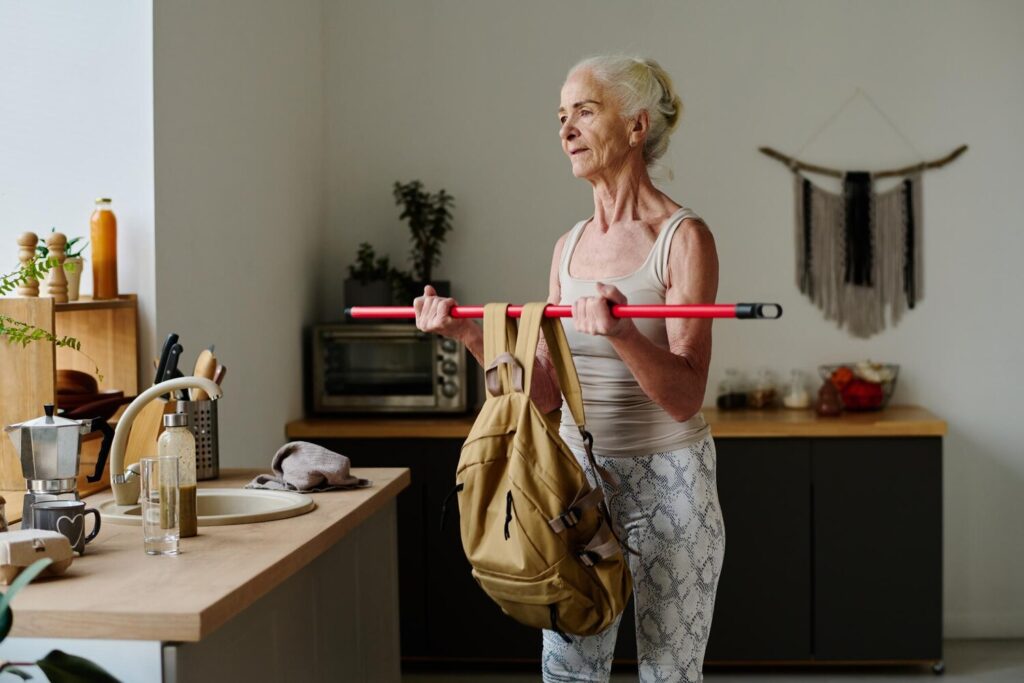 retired woman lifting heavy backpack 274679 47043
