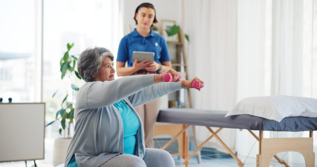 senior woman dumbbells checkup with physiotherapist stretching mobility exercise rehabilitation people tablet patient recovery physical therapy progress report assessment 590464 531798 senior woman dumbbells checkup with physiotherapist stretching mobility exercise rehabilitation people tablet patient recovery physical therapy progress report assessment 590464 531798